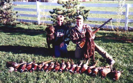My daughter Brooke and her husband Rick Littrell with their Cedarwoods Calendar Girl (Cally) and her son Cedarwoods Icelus (Ice) on an Idaho pheasant opener.
  Cally is the breeds top producer of all time and her name is on the pedigree of nearly every puppy that leaves our kennel.
