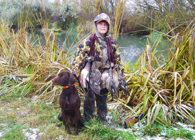 Grandson Hunter Farris with his 5 month old pup Hidden Acres Atlas (aka Romo).  Hunter can be found every Saturday in the duck blind handling his dog for Grandpa and his friends.